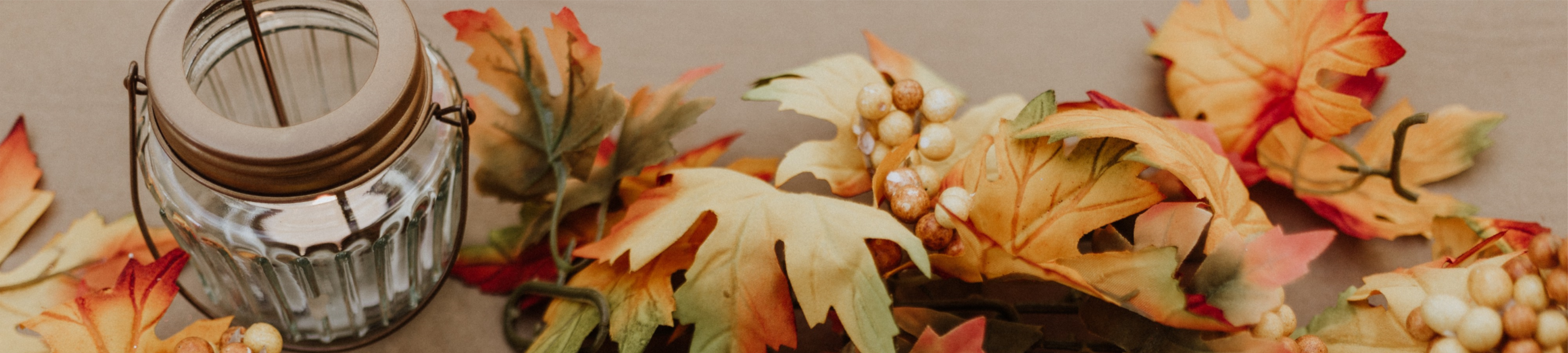 Leaves and candle in fall colors 